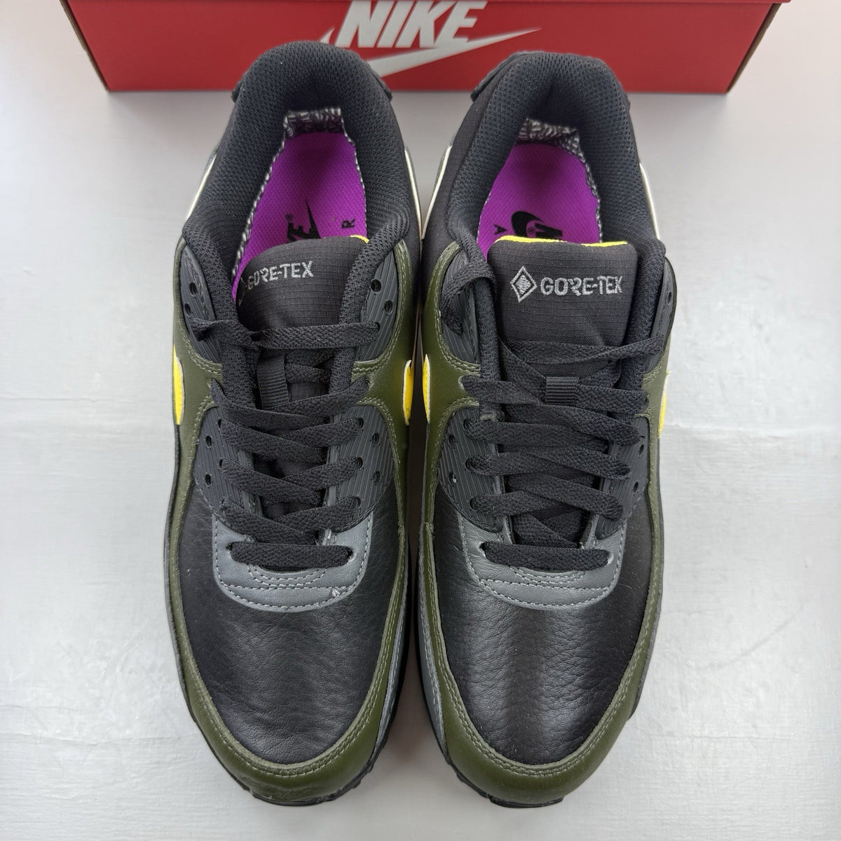 Nike Air Max 90 trainers black with Gore-Tex material and cargo khaki accents.