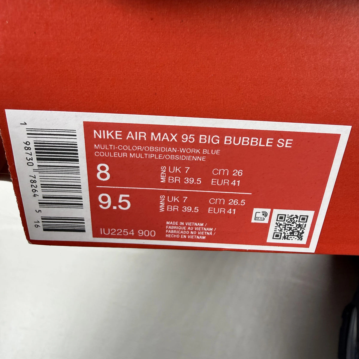 Nike Air Max 95 blue trainers with big bubble sole and branded logo details.