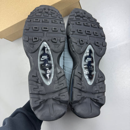 Nike Air Max 95 grey trainers with caution strip detailing and black accents.