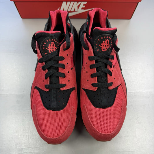 Nike Air Huarache trainers red and black with distinctive logo and unique design details.