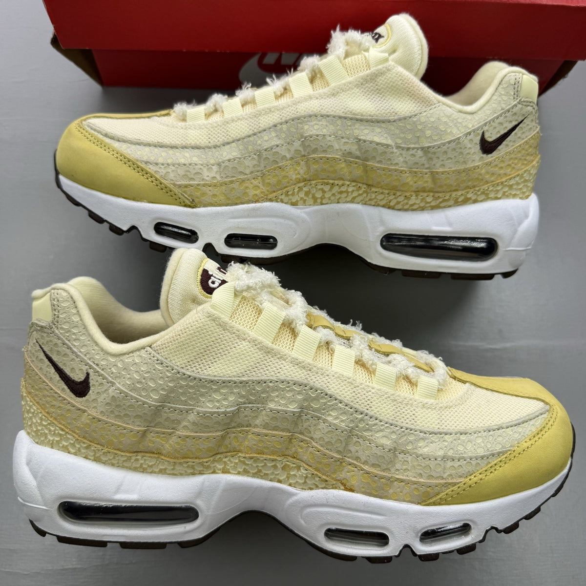 Nike Air Max 95 trainers yellow with textured upper and signature swoosh logo.