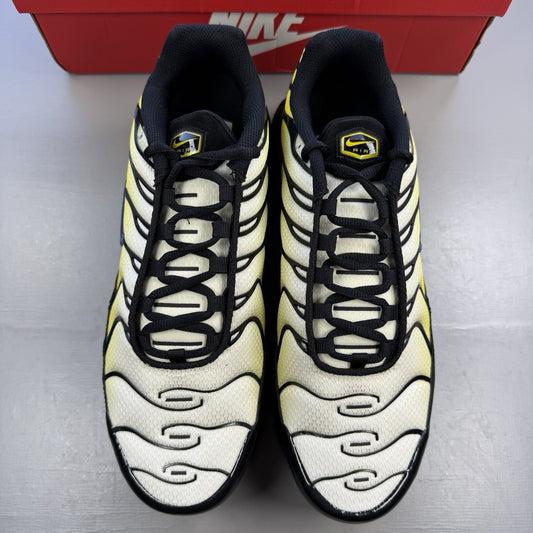 Nike Air Max Plus TN black trainers with bright citron yellow accents and signature logo.
