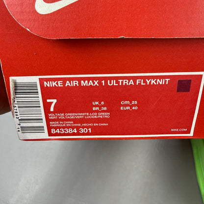 Nike trainers green Flyknit upper with Air Max cushioning and logo detail.