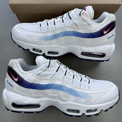 Nike Air Max 95 trainers white with blue and red accents, featuring iconic logo detailing.