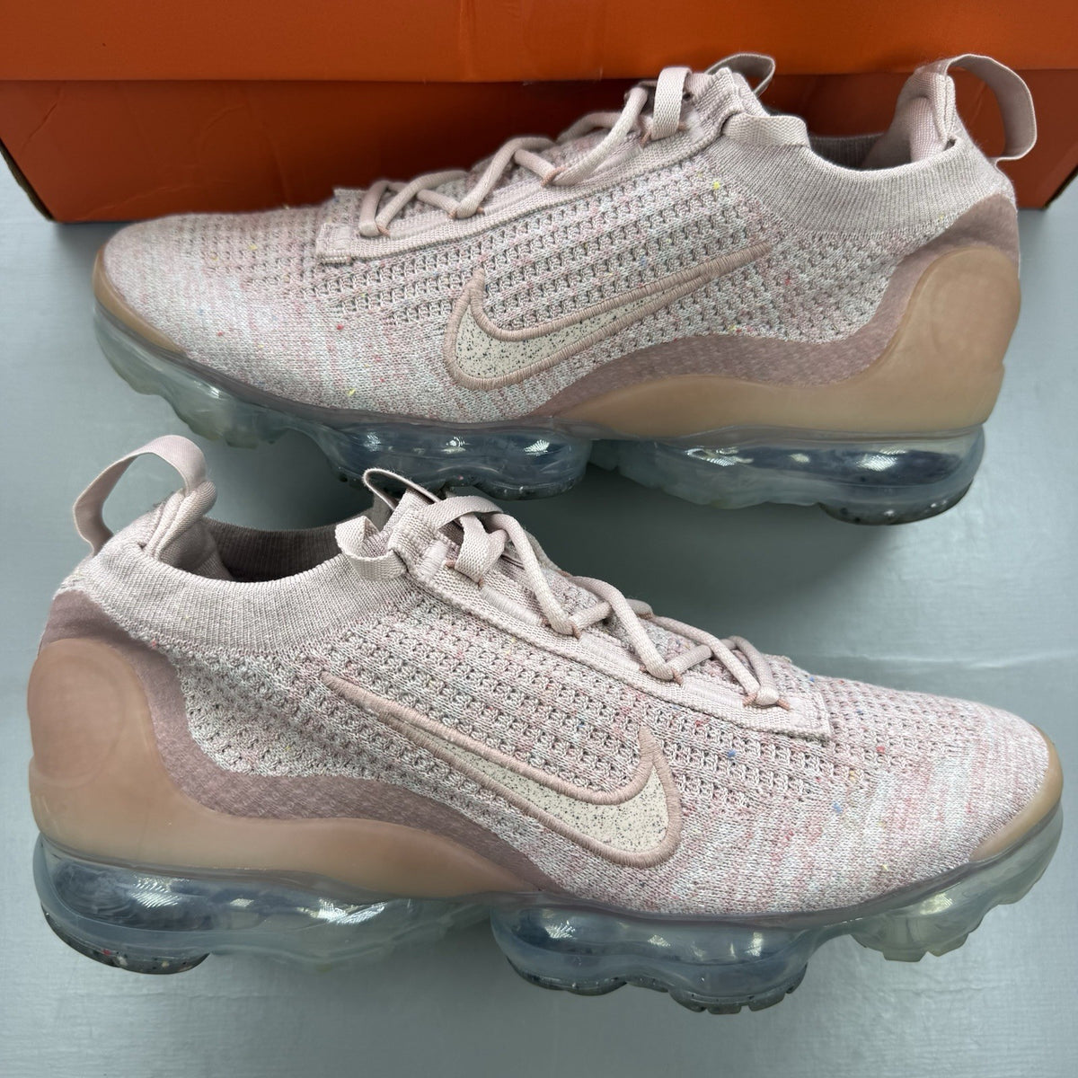 Nike Air VaporMax 2021 Flyknit pink trainers with breathable knit upper and signature logo.
