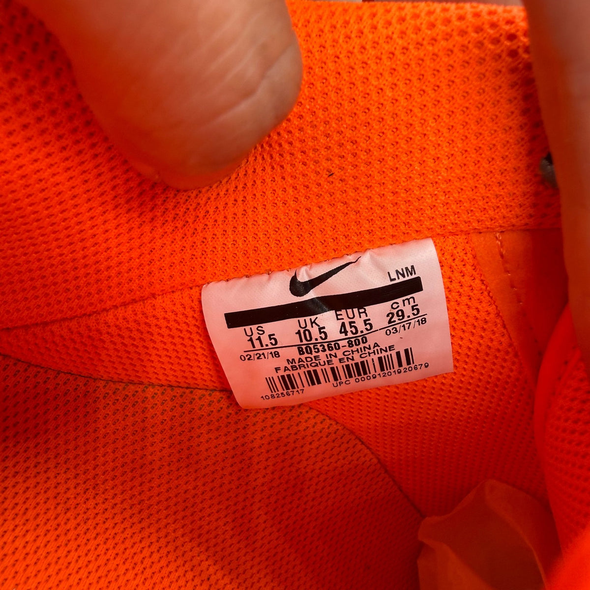 Nike Air Force 1 Low orange trainers with 'Just Do It' logo and sleek design.
