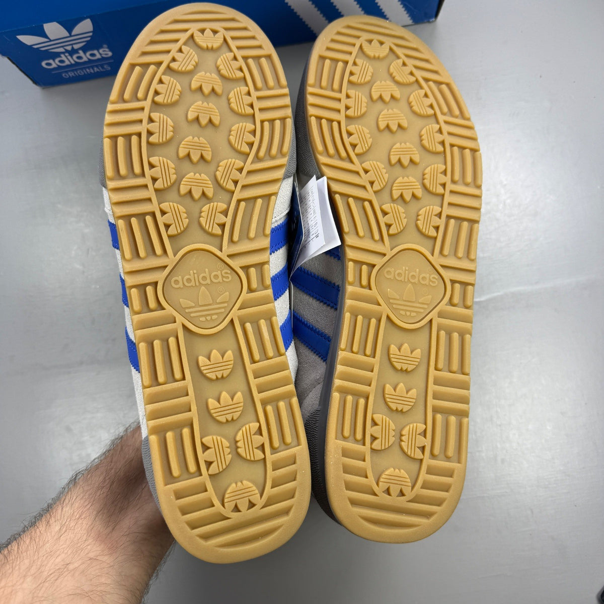 Adidas grey deck shoes with suede material and logo detail.