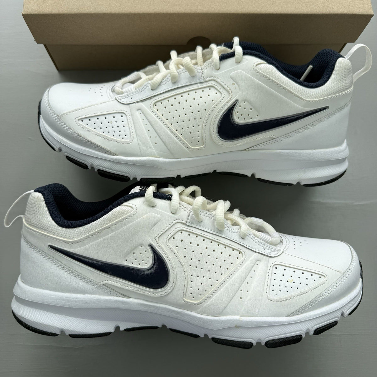 Nike T-Lite XI white trainers with obsidian and black accents, featuring a sleek design.