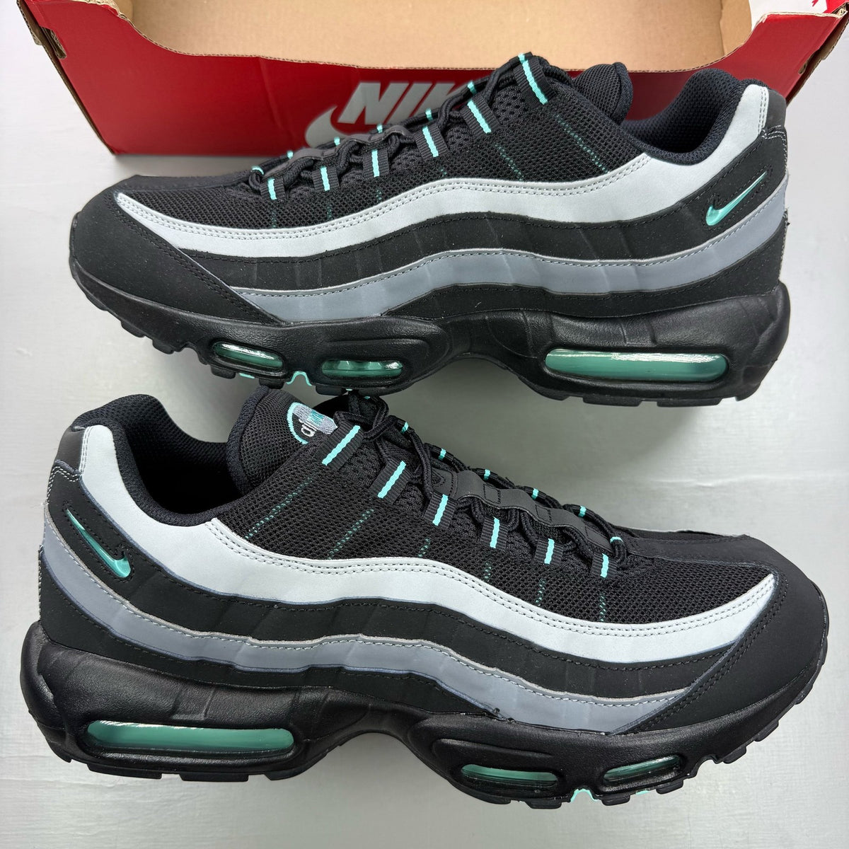 Nike Air Max 95 black trainers with Aurora Green and Grey accents, featuring iconic logo.