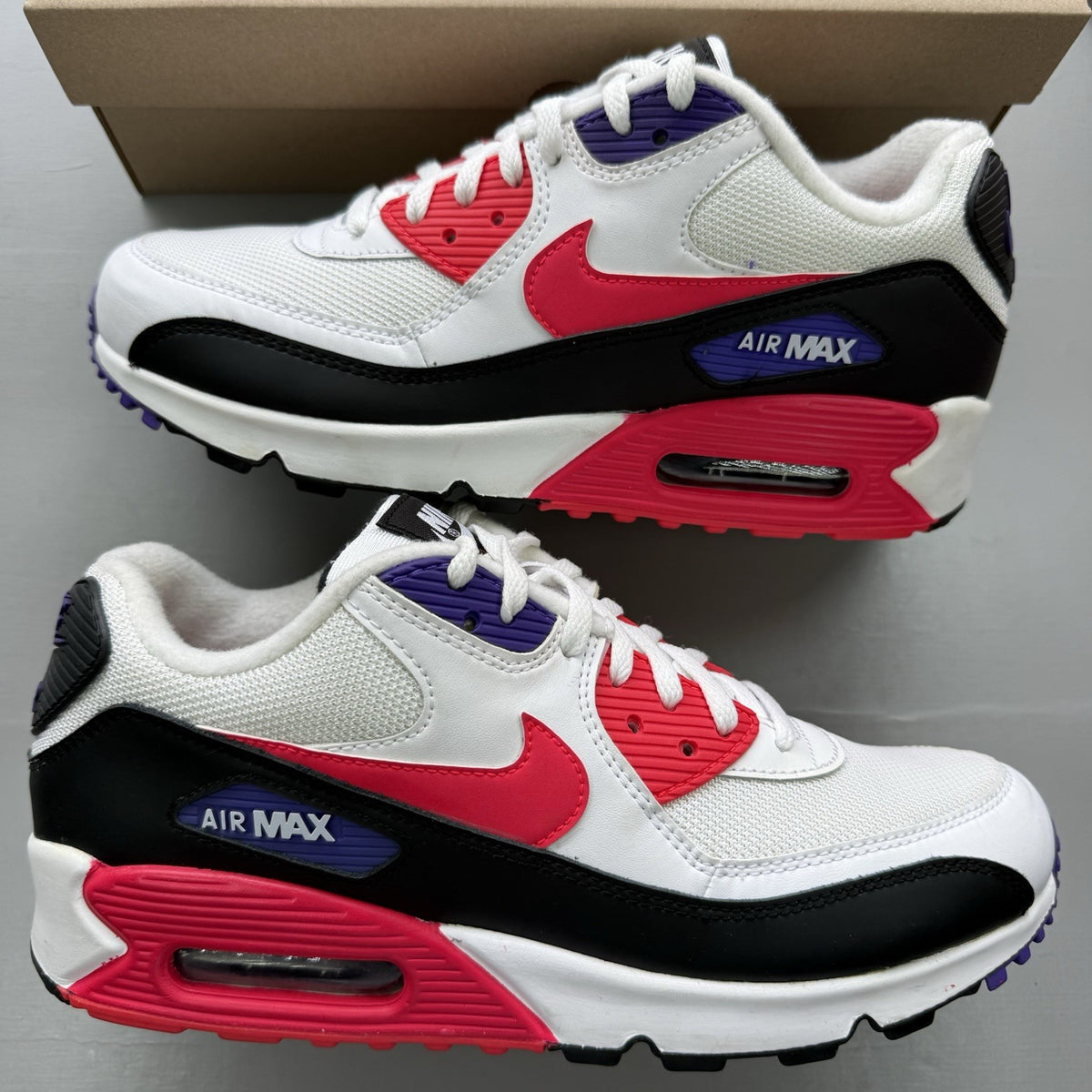 Nike Air Max 90 Raptors white trainers with red, purple, and black accents.