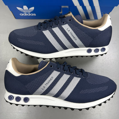 Adidas blue athletic shoes with white accents and textured weave design.