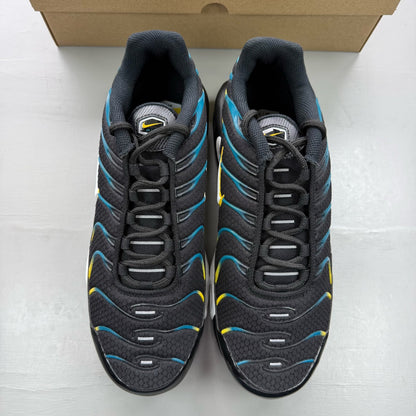 Nike Air Max Plus TN black trainers with teal and yellow accents, featuring logo detailing.
