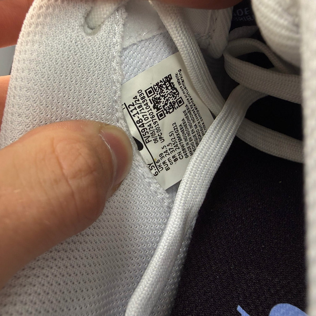Nike Air Force 1 low white trainers with grey cement accents and logo detailing.