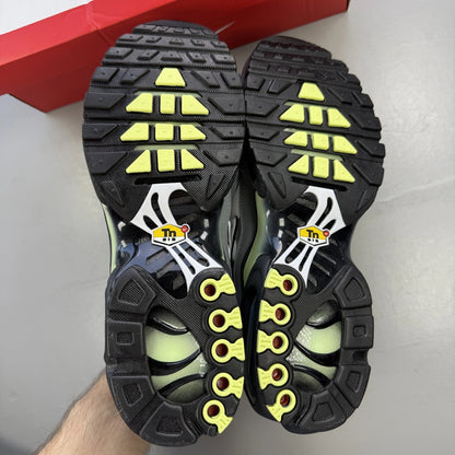 Nike Air Max Plus TN grey trainers with white and liquid lime accents, logo detail.