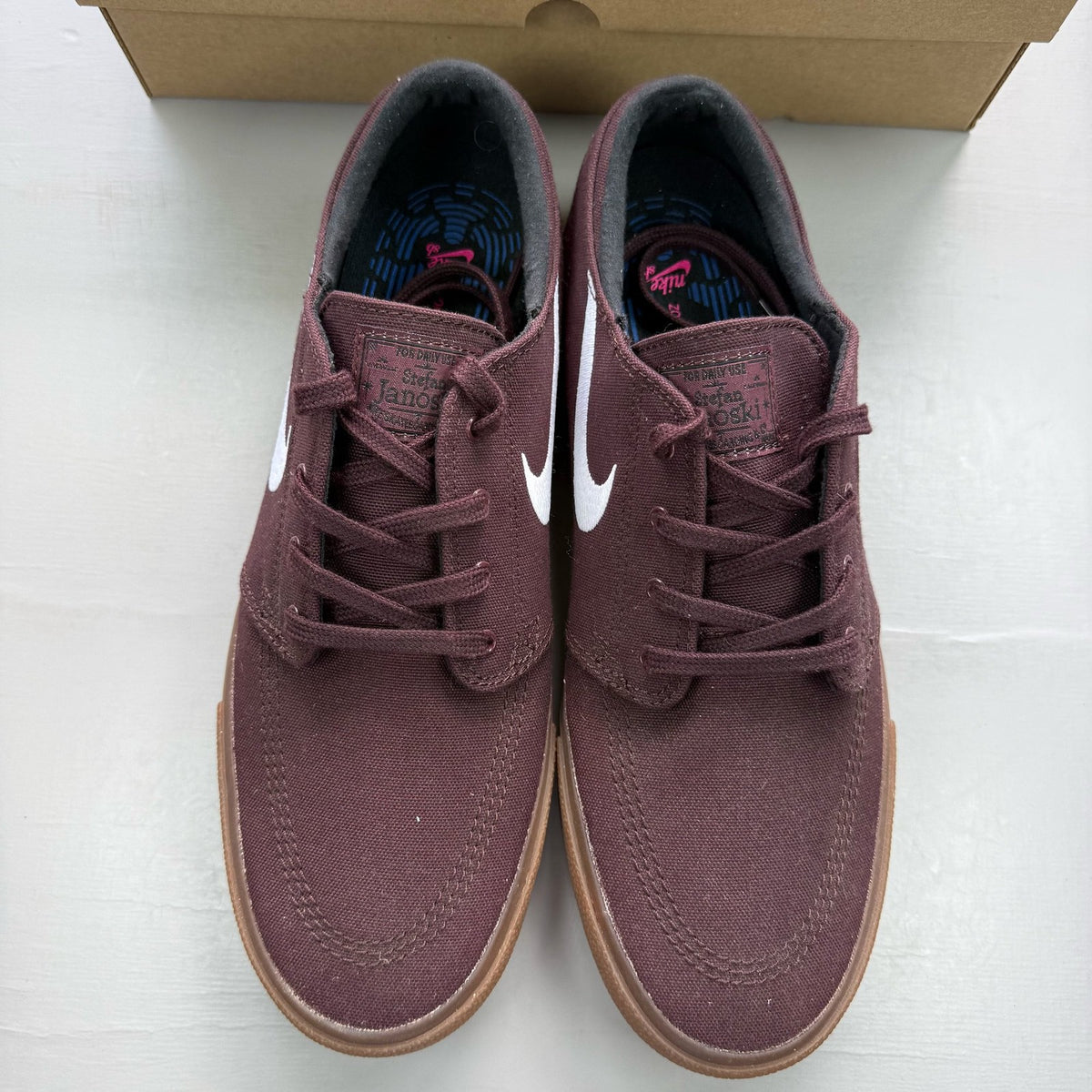 Nike SB Stefan Janoski burgundy trainers with gum sole and white accents.