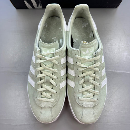 Adidas green deck shoes with white accents and logo detailing.