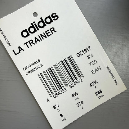 Adidas blue LA Trainer sneakers with white stripes and logo detailing.