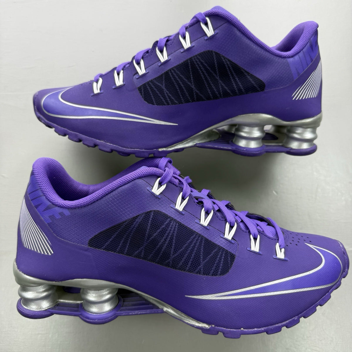 Nike trainers purple with silver accents and distinctive Shox cushioning system.