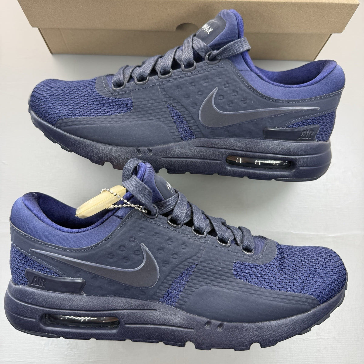 Nike Air Max Zero blue trainers with black accents and logo detailing.