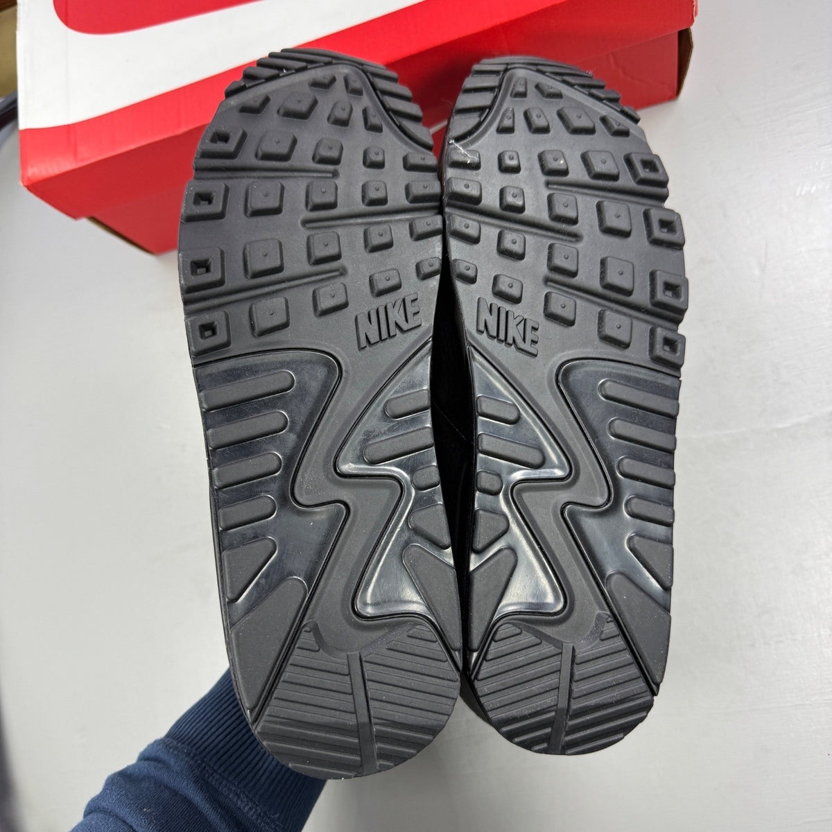 Nike athletic shoes black leather with Air Max branding and textured design.