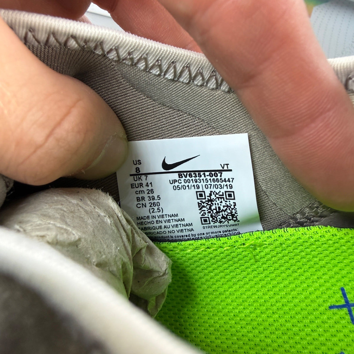 Nike running shoes beige with Air VaporMax sole and utility design.