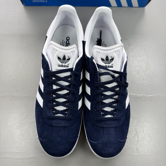 Adidas blue trainers with white stripes, suede material, classic logo detailing.