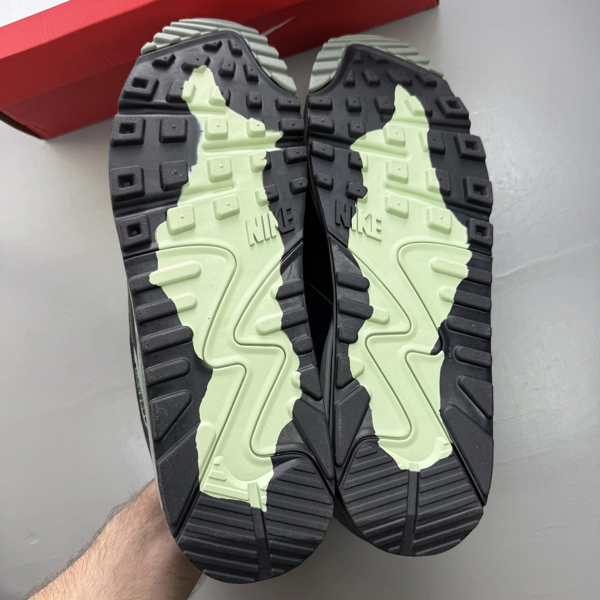 Nike Air Max 90 black trainers with Gore-Tex material and honeydew accents.