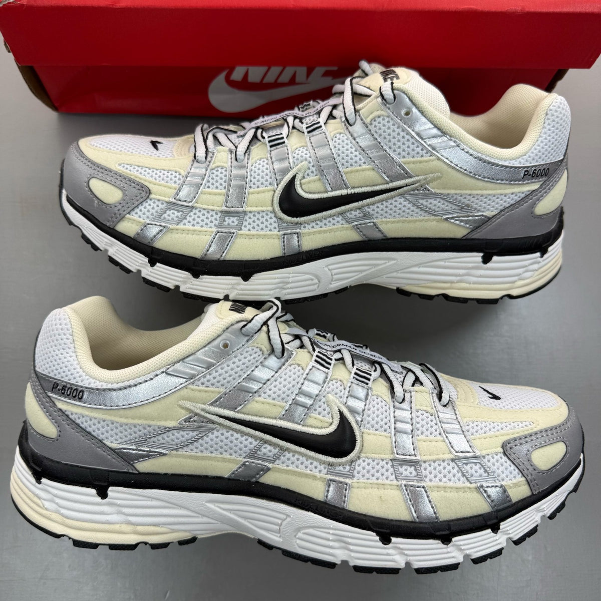 Nike P-6000 white trainers metallic silver accents and mesh detailing.