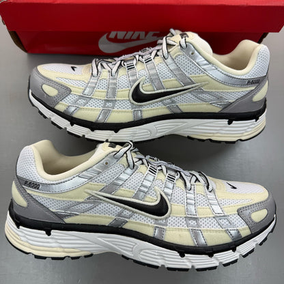 Nike P-6000 white trainers metallic silver accents and mesh detailing.