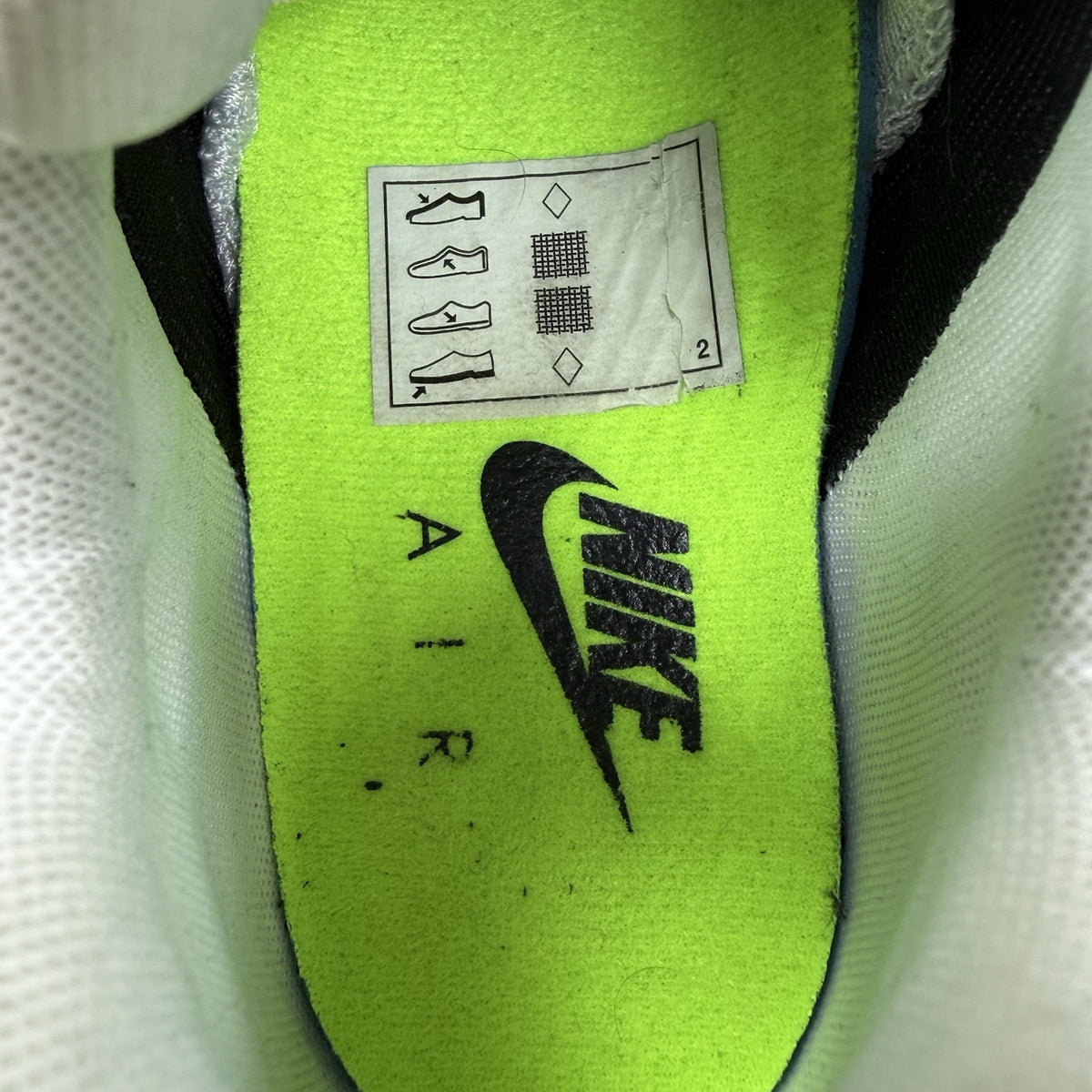 Nike Air Max 95 NDSTRKT black trainers with neon accents and textured mesh upper.
