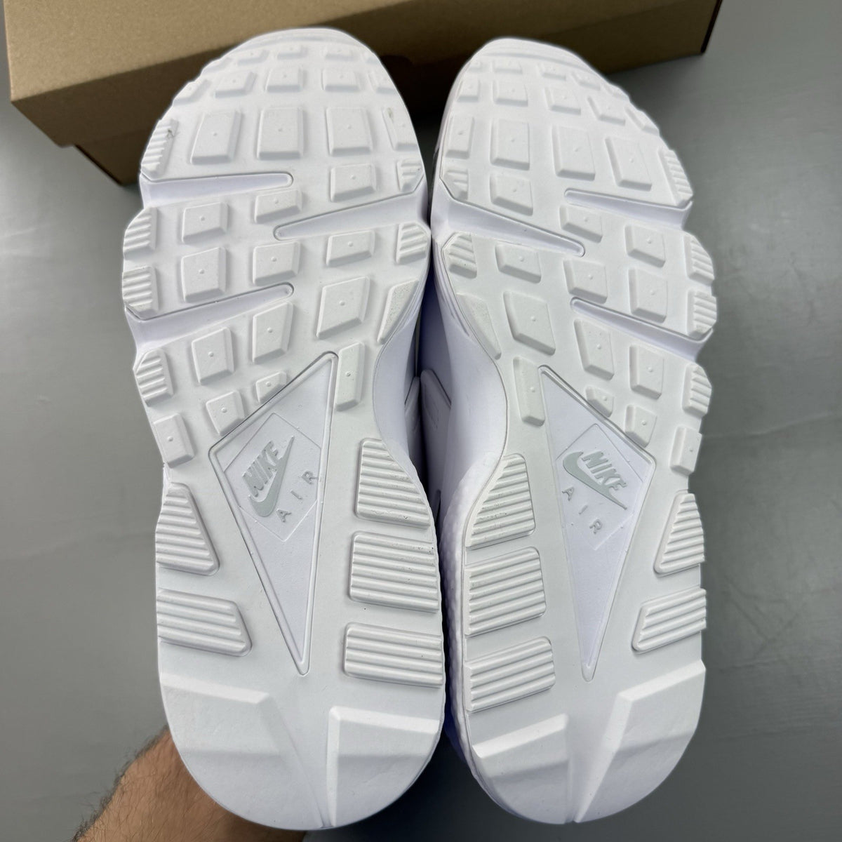 Nike Air Huarache white trainers with Pure Platinum accents and signature logo details.
