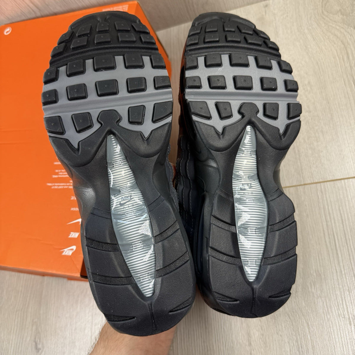 Nike Air Max 95 trainers grey with black accents and textured material.