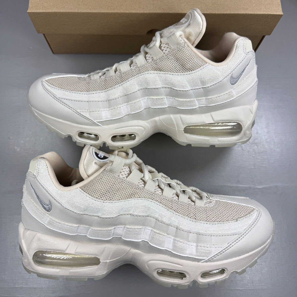 Nike trainers white with big bubble sole and iconic swoosh logo.