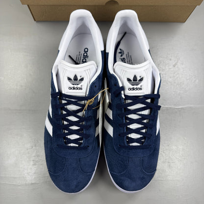 Adidas blue suede trainers with white stripes and logo detail.