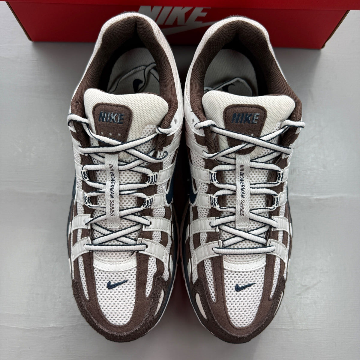 Nike deck shoes brown with white accents and logo detail.