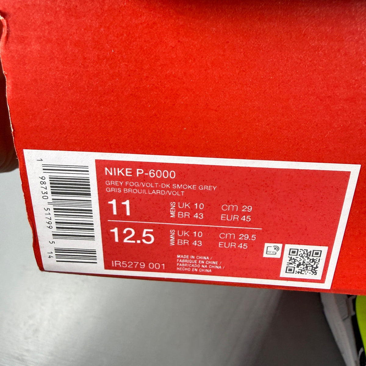 Nike athletic shoes grey with black and volt accents, mesh upper and logo detail.