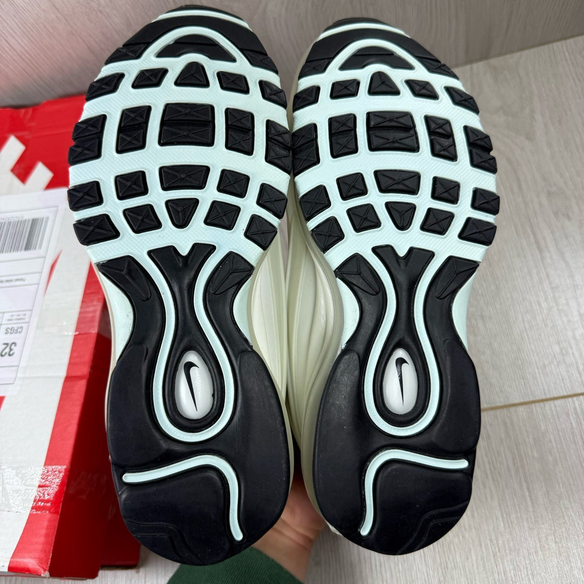 Nike Air Max Deluxe SE beige trainers with unique pattern and logo details.