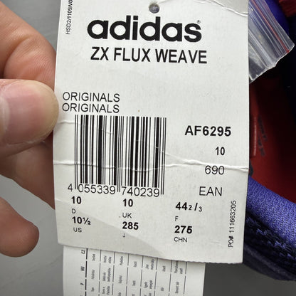 Adidas blue ZX Flux trainers with red and white woven pattern, logo on tongue.