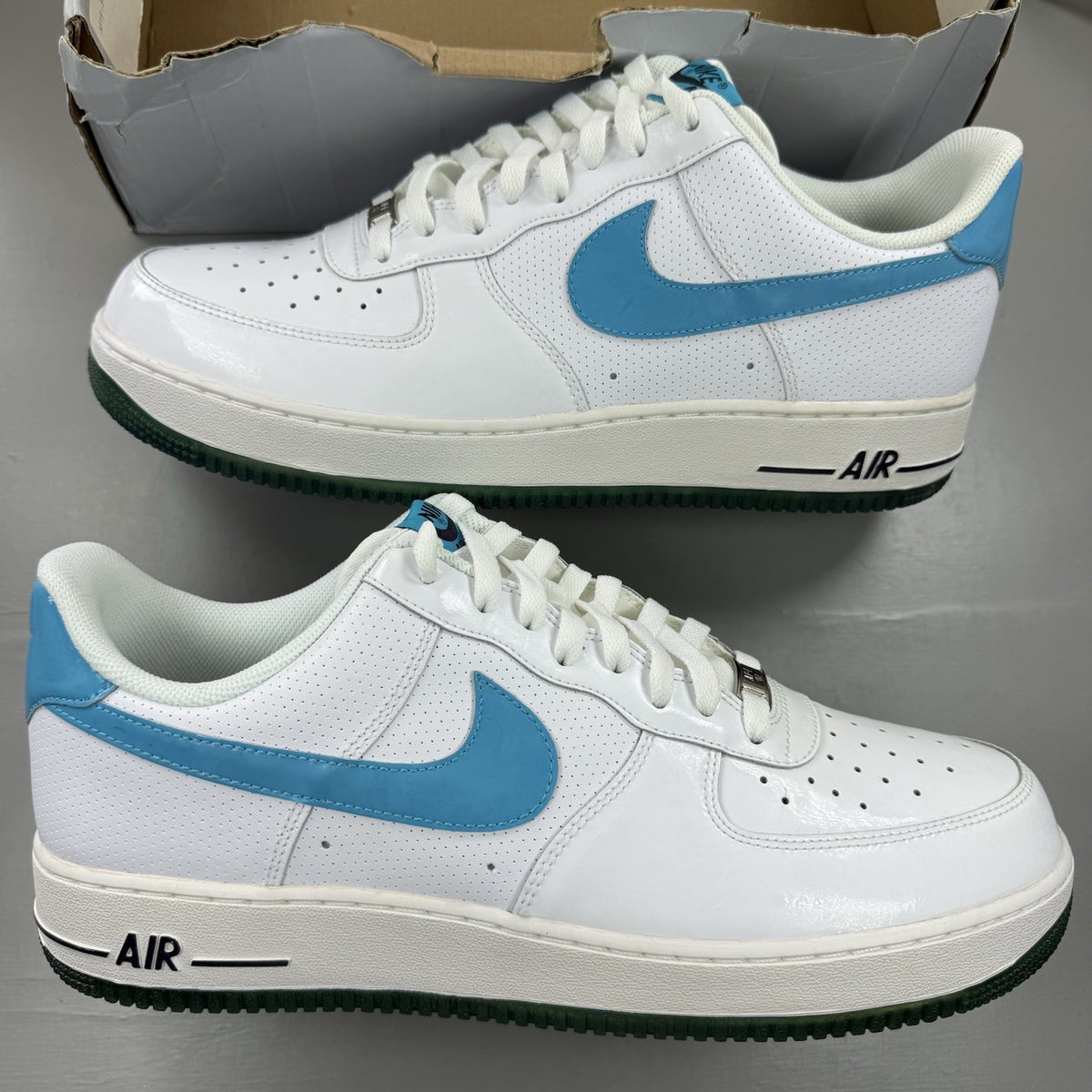 Nike Air Force 1 trainers white with marina blue and dark obsidian accents.