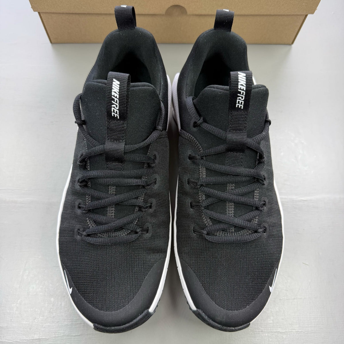 Nike black trainers with white accents and breathable mesh upper.
