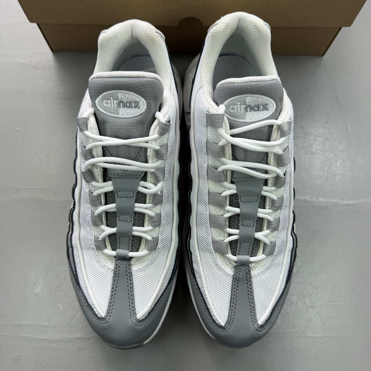 Nike Air Max 95 grey sneaker with white accents and reflective detailing.