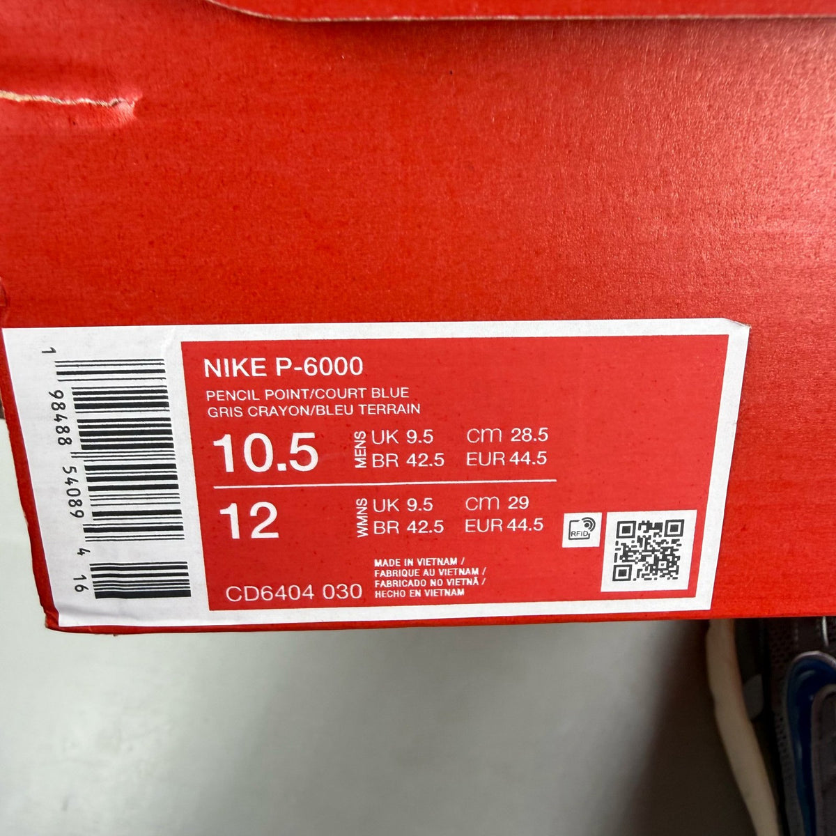 Nike grey blue trainers with pencil point design and logo detail.