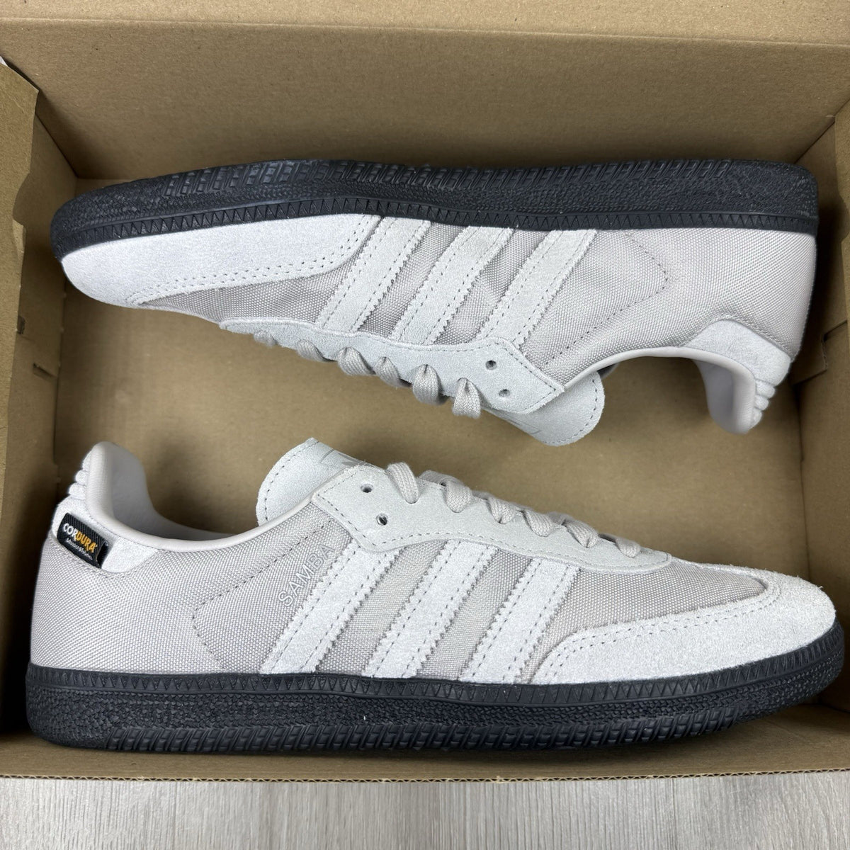 Adidas grey trainers with Cordura material and classic Samba logo detailing.