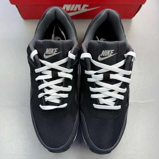 Nike Air Max 1 black trainers with silver and white accents, featuring iconic logo.