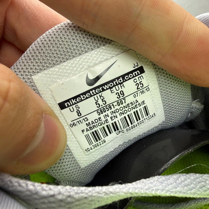 Nike grey trainers with black accents and distinctive Free 5.0 design.