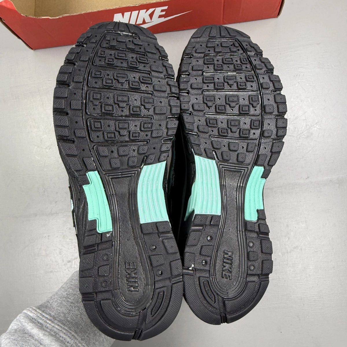 Nike black trainers with Cool Grey and Hyper Turquoise accents, featuring a sleek design.