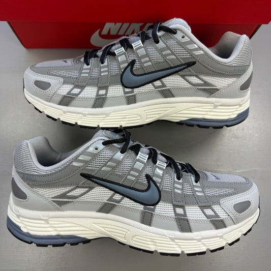 Nike athletic shoes light smoke grey with blue graphite accents and logo details.