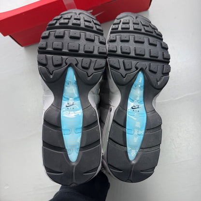 Nike trainers grey with aqua accents and retro logo detailing.