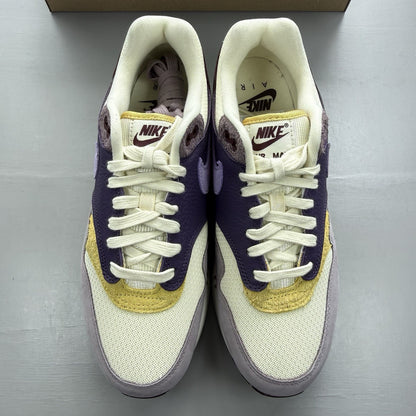 Nike Air Max 1 87 trainers grey with violet accents and signature swoosh logo.