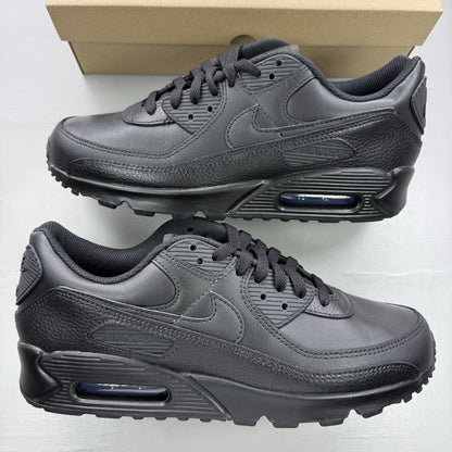 Nike Air Max 90 trainers black leather with signature swoosh logo and textured detailing.